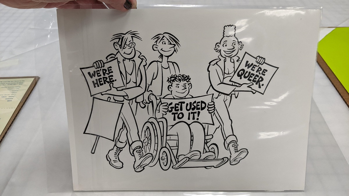 Cartoon-like line drawing of three people, one in a wheelchair, most holding signs